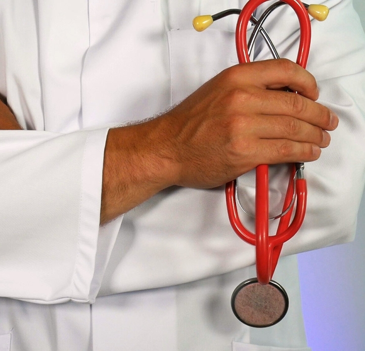 Doctor with crossed arms holding a stethoscope